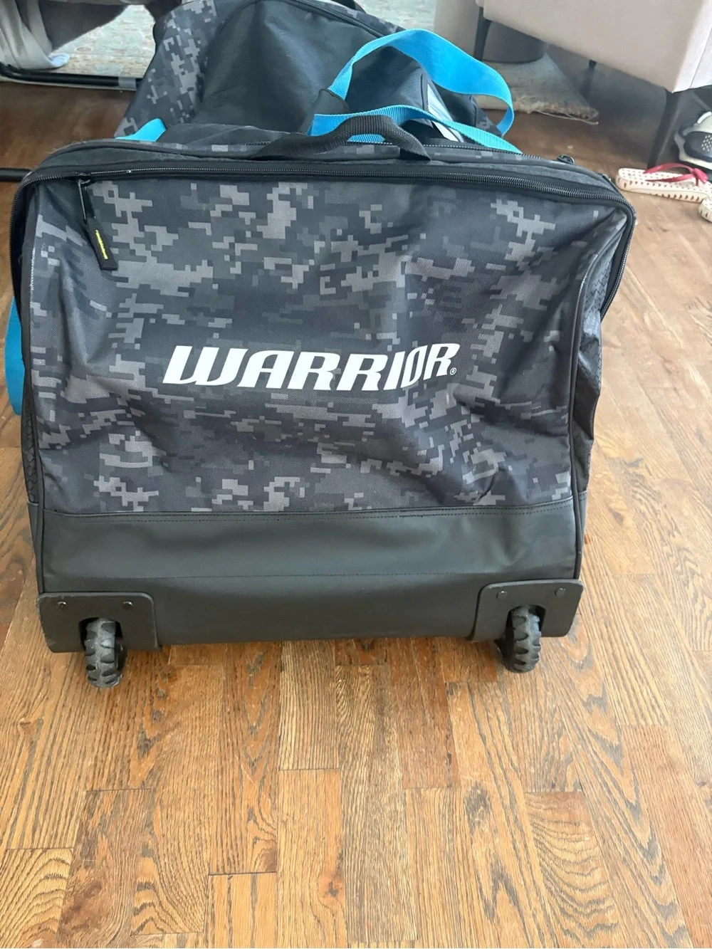 Men's hockey Duffle Bag in Black Digital Camo with Blue Accents wheeled